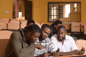 Wall Mural - Happy young African university students studying with books in school library