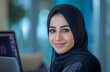 © Mardy Elzaawely - Young arab woman wearing hijab working on laptop at home or office