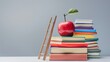 © HendraGalus - School and education promotional banner background with copy space, apple on stack of books with ladder