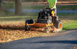 © Susan - Worker on  a Standing mower and leaf mulcher, doing fall clean  up