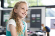 © Wavebreak Media - In school, in the classroom, a young Caucasian girl with curly blonde hair smiles with copy space