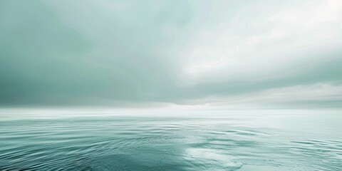 Wall Mural - A calm ocean with a cloudy sky in the background