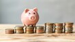 © lemoncraft - Piggy Bank on Rising Coin Stacks. A pink piggy bank sitting atop progressively taller stacks of coins, representing financial growth and savings strategy.