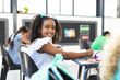 © Wavebreak Media - A biracial girl in white dress smiles in a classroom