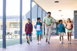 © Wavebreak Media - In school, diverse group of young students walking with their Asian teacher