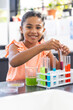 © Wavebreak Media - In school, young biracial female student is conducting a science experiment