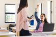 © Wavebreak Media - A student raises her hand in a bright classroom in high school, with copy space