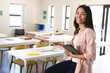 © Wavebreak Media - Young biracial woman stands confidently in a classroom in high school