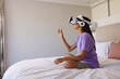 © Wavebreak Media - A biracial young female at home, wearing virtual reality headset, copy space