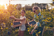 © astrosystem - Mother and daughter picking blueberries on a family organic farm.