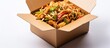 © Ilgun - Asian ramen noodle dish with shrimp, veggies, soy sauce, and scallions in a white take-out box, embodying a rapid delivery street food idea with a copy space image.