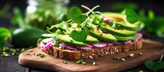 Poster - Rye bread topped with avocado, cucumber, and radish sprouts on a plate with copy space image.