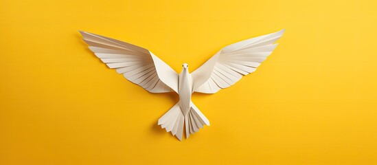 Wall Mural - a peace symbol represented by an origami paper dove against a yellow background with copy space imag