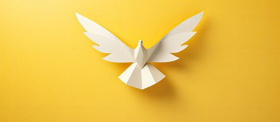Wall Mural - a peace symbol represented by an origami paper dove against a yellow background with copy space imag