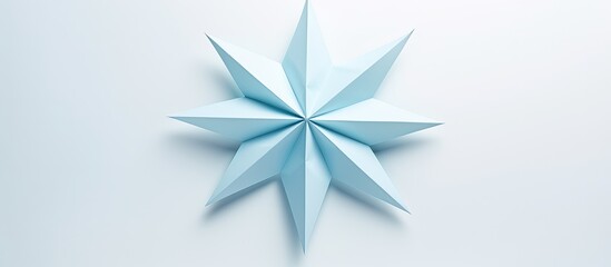 Wall Mural - Origami star made of blue paper placed on a white background with copy space image.