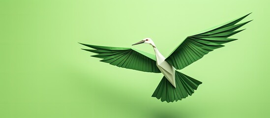 Wall Mural - close-up of a paper origami crane on a green background with copy space image.