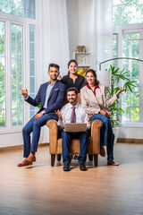 Wall Mural - Group of young Indian asian business professionals using laptop in office