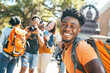 © Jane_S - Smiling young man with a backpack enjoying his day on a college campus.