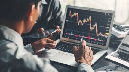 Wall Mural - A financial advisor discussing stock market trends with a client, pointing to a graph on a laptop screen during a consultation