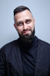 © Loginova - Studio portrait of young handsome man with beard.