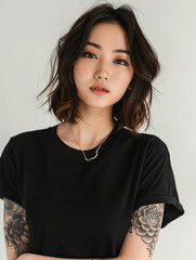 Wall Mural - young Asian woman with tattoos, wearing a black t-shirt, showcasing modern style and personal expression