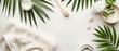 © nattapon98 - A flat lay of spa and wellness items including towels, creams, and palm leaves, set on a white background for a serene and natural aesthetic.