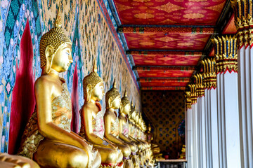 Rows of Buddha statues in a Thai temple in Bangkok