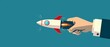 © JK_kyoto - Businessmans hand propelling a rocket upwards representing accelerated business achievements and new venture concepts