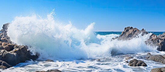 Poster - Rough White Ocean Foam Crashing On Ragged Beach Rocks. Creative banner. Copyspace image