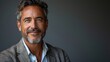© Wiseman - manager or ceo portrait of a smiling businessman in a white studio background peering at the camera .hight relustion