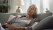 © Argun Stock Photos - senior woman sitting on sofa relaxing