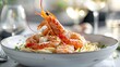 © Riccardo - Italian linguini pasta with succulent prawns, fresh herbs, and grated parmesan, served on a stylish dining table