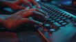 © Ilia Nesolenyi - A close-up shot of a programmers hands typing on a keyboard, with the fingers pressing down on the keys. The image is shot in a dark room with a blue and red glow