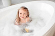 © Pixel-Shot - Cute little girl with foam taking bath in bathroom