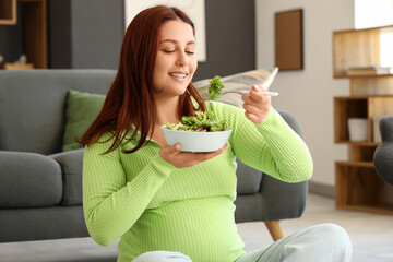 Poster - Young pregnant woman eating fresh vegetable salad at home