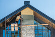 © Tomasz Zajda - Construction Worker Installing Stone Veneer on a Modern Home