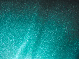 Wall Mural - light reflects blue shadows on a foam board in the dark for a minimalist abstract background.