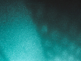 Wall Mural - light reflects blue shadows on a foam board in the dark for a minimalist abstract background.