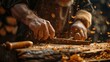 © INsprThDesign - Close-up of a carpenter's hands working on a piece of wood, with sawdust flying in the air.