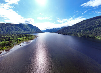 Wall Mural - beautiful landscape with mountains and Lake Teletskoye against a background of blue sky from a drone in May