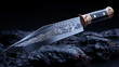 © h3design - A meticulously crafted knife with intricate carvings lies on a dark, rocky surface. The blade reflects light, showcasing its ornate design