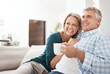 © Jadon Bester/peopleimages.com - Relax, coffee and mature couple on sofa for love, connection or bonding together in living room. Romance, smile and married people for healthy relationship, conversation or weekend break in home