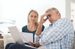 © Jadon Bester/peopleimages.com - Couple, couch and document with laptop and stress, finances or taxes for debt in living room. Paperwork, planning or online for mortgage, upset people and budget for inflation or bankruptcy in home
