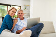 © peopleimages.com - Couple, couch and laptop with portrait in home, streaming and relax in living room for movies. Internet, computer and point for website for video with mature married people, lounge and technology
