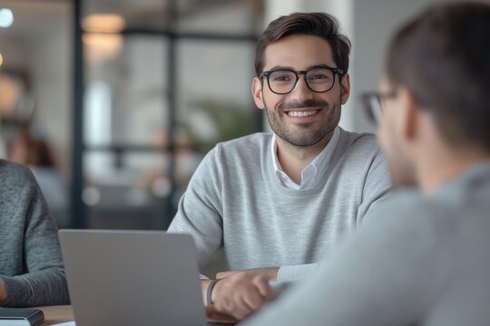 Happy business man having a meeting with his team 