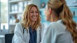 © Togrul - Smiling female patient at consultation with woman doctor. Patient Having Consultation With Doctor In Office. Cropped shot of a medical practitioner reassuring a patient