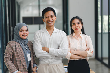 Wall Mural - Diverse business team standing together in modern office.