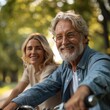 © banthita166 - Warm Toned Closeup of Happy Senior Couple Smiling While Cycling Together