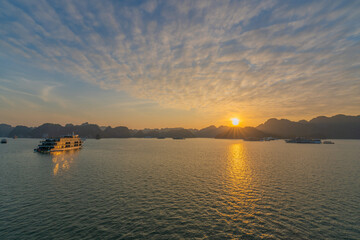 Poster - a boat in the water during sunset on a lake with mountains in the background