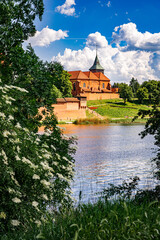 Wall Mural - Ancient medieval village church reflected in the river water	
